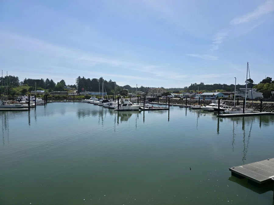 Boats moored in the Port of Bandon boat basin under a clear sky