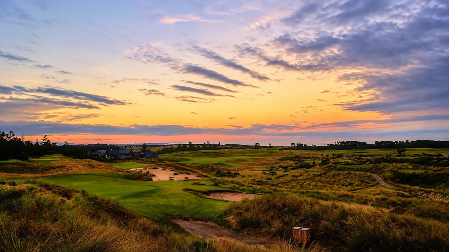 Sweeping links golf course and lodge at sunset on the Bandon coast